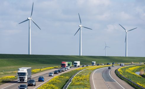 Dutch motorway near Lelystad with wind turbines and blooming rapeseed Dutch motorway A6 near Lelystad with wind turbines and blooming rapeseed